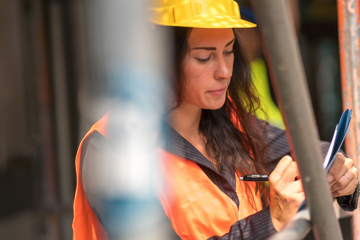 Female Legionella risk assessor conducting on-site survey
